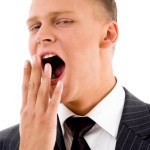 yawning young manager on an isolated background
